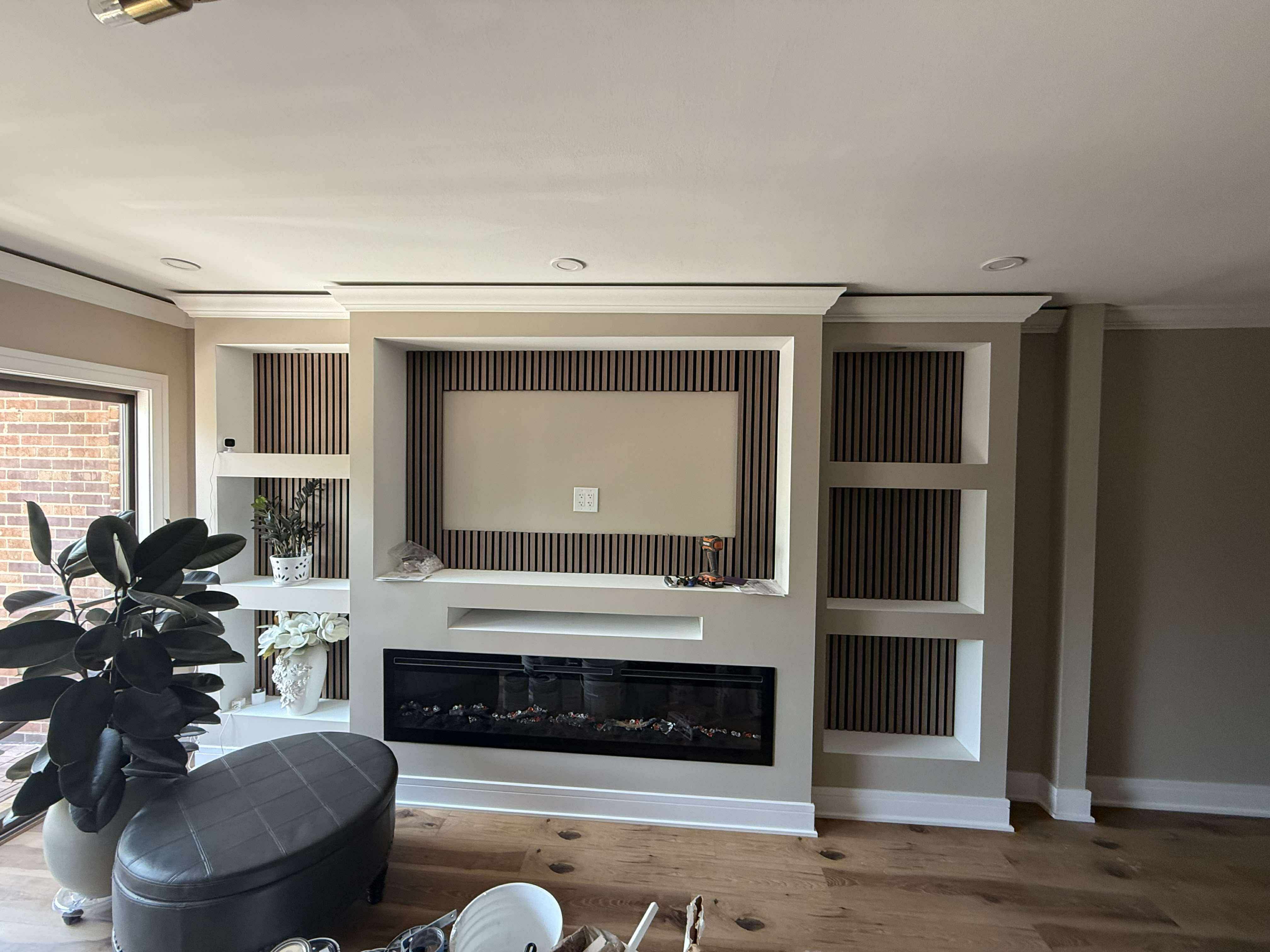 Custom living room feature wall with built-in fireplace and shelving
