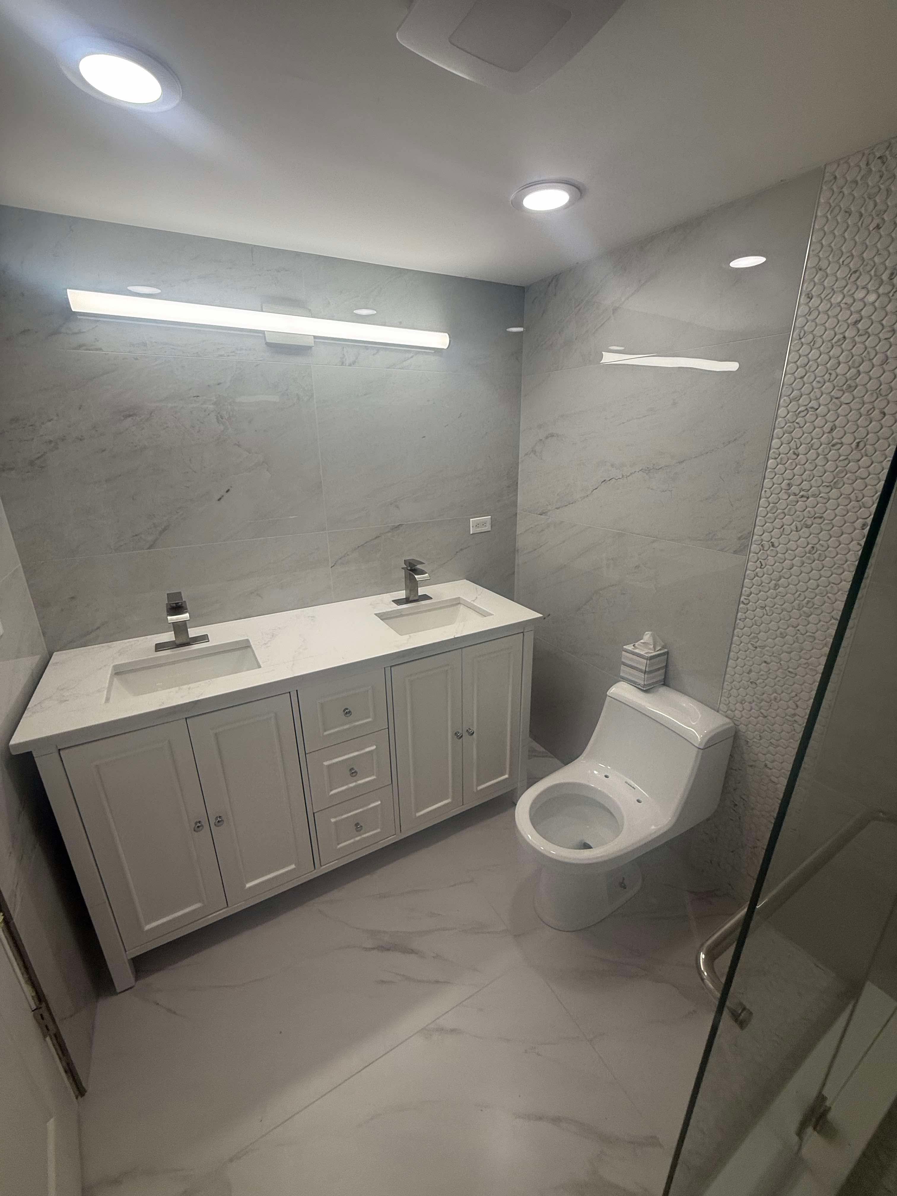 Bathroom remodel with double vanity and large-format tile